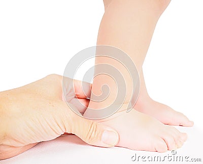 Male hand holding firmly around a foot of toddler Stock Photo