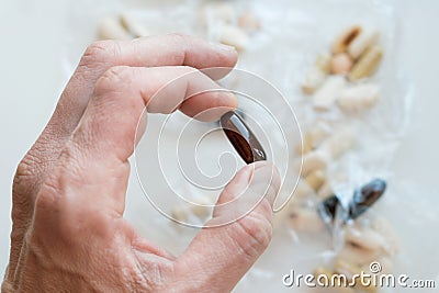 Male hand holding gelatin bioactive dietary supplement pill Stock Photo