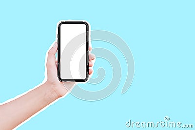 Male hand holding smartphone with mockup, isolated with white contour on blue. Stock Photo