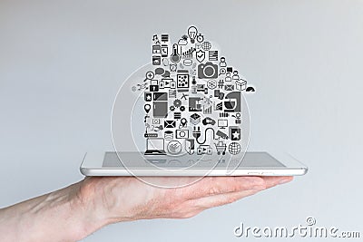 Male hand holding tablet computer. Concept of smart home automation and mobile computing. Stock Photo