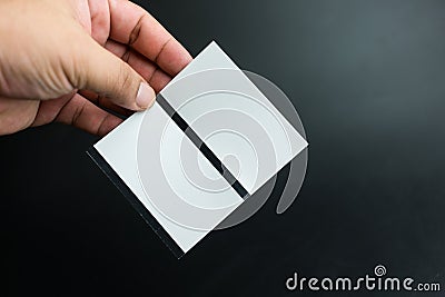 Male hand holding two blank sheets of paper tickets Stock Photo