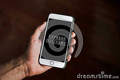 hand holds a smartphone with the words express delivery Stock Photo