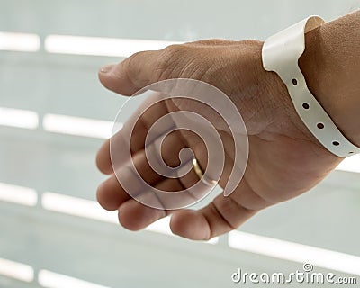 Male hand with newborn birth tag Stock Photo