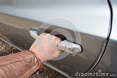 Male hand opens the car door with inner handle Stock Photo