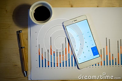 Male hand pointing at a column chart printed on a white sheet of paper during a business meeting Stock Photo