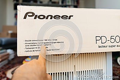 Male hand pointing to the text of new Pioneer PD-50-2 super audio cd SACD Editorial Stock Photo