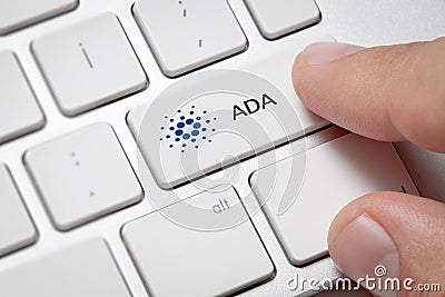 Male hand pressing computer key with CardanoADA Editorial Stock Photo