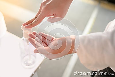 Male hand pumping bottle of alcohol sanitizer Stock Photo