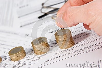 Male hand putting money on growing coin stack Editorial Stock Photo