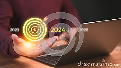 Male hand show the goal icon, Goal 2024 for working, success, savings money, good health, life balance, travel plan. Stock Photo