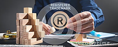 Male hand showing R-Registered trademark Stock Photo