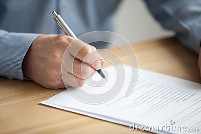 Male hand signing document, senior man putting signature on pape Stock Photo