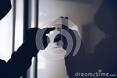 The male hand of a thief pressing the code for a home alarm Stock Photo