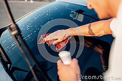 Male hand with tool for washing windows, car wash Stock Photo