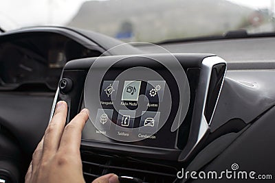 male hand touching screen in modern car Stock Photo