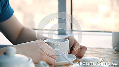 Male hand and white cup. Man holding blank cup, closeup. Closeup portrait of a young handsome man having a cup of coffee Stock Photo