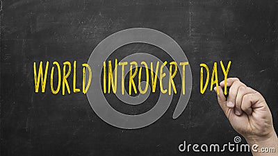Male hand writing the words World Introvert Day on chalkboard Stock Photo