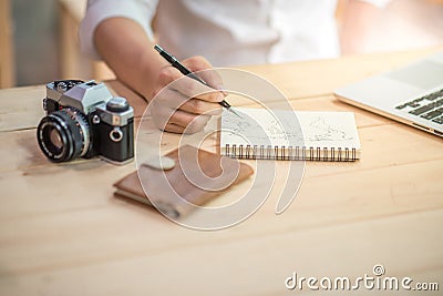 Male hand writing world outline on notebook Stock Photo