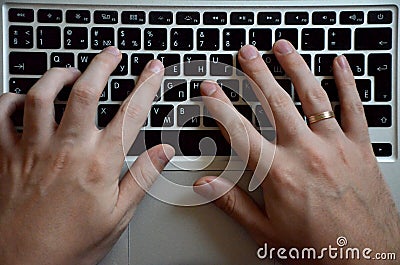 Male hands on a black keyboard. European working on a computer Stock Photo