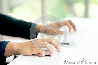 Male Hands Clicking Wireless Computer Mouse Laptop computer on Office Table Stock Photo