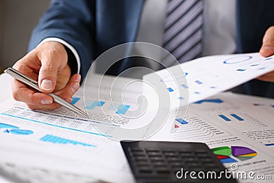 Male hands hold documents with financial statistics Stock Photo