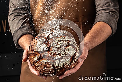 male hands holding bread. domestic cozy bakery pastry. Healthy food concept. place for text Stock Photo