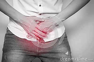 Male hands holding on middle crotch of trousers with prostate inflammation, Prostate cancer, Men`s health care concept Stock Photo