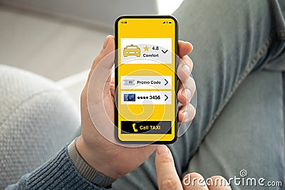 Male hands holding phone with call taxi app on screen Stock Photo