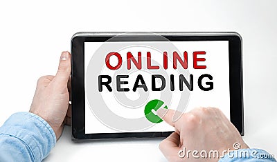 Male hands holding tablet pc with text ONLINE READING Stock Photo