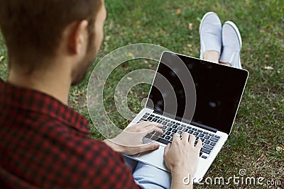 Male hands with laptop, over shoulder shot Stock Photo