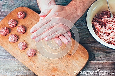 Male hands prepare homemade meat balls Stock Photo