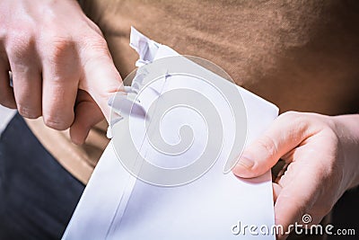 Male Hands Ripping Open The Edge Of An Envelope - Impatient Waiting For A Message Concept Stock Photo