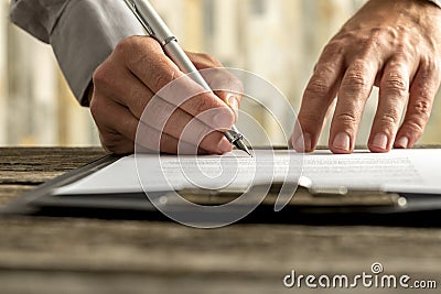 Male hands signing document, contract or application form Stock Photo