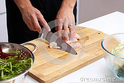 Male hands slicing chicken Stock Photo
