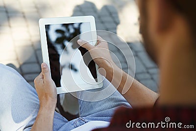 Male hands with tablet, over shoulder shot Stock Photo