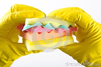 Male hands in yelliw gloves holding a burger made from sponges different colors. Concept of unhealthy food and non Stock Photo