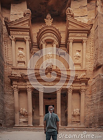 Male in a headscarf standing in front of the historic Petra Wadi in Jordan Editorial Stock Photo