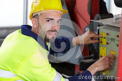 male heavy equipment operator pressing control Stock Photo