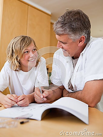 Male helping son with homework Stock Photo