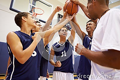 Male High School Basketball Team Having Team Talk With Coach Stock Photo