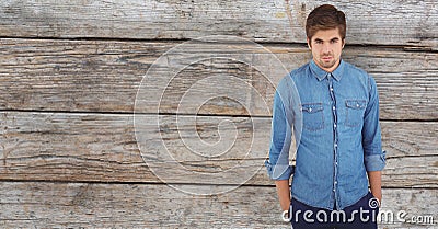 Male hipster with hands in pockets against wooden wall Stock Photo