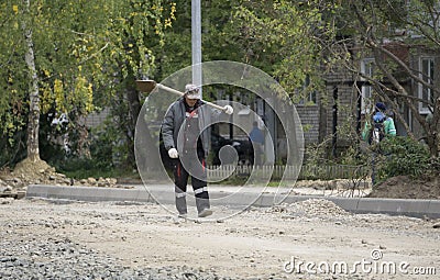 Male holding shovel and looking at sky Russia Berezniki 4 September 2017 Editorial Stock Photo