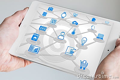 Male holding tablet in both hands with internet of everything (IOT) concept. Stock Photo