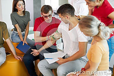 Male instructor use tourniquet to prevent bleeding during first aid training Stock Photo