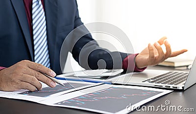 Male investment businessman has analyzed the market of the stock graph and evaluated the financial risks with the Business Intelli Stock Photo