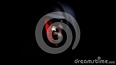 Male isolated on black background, red lights, escape from prison, conspiracy Stock Photo
