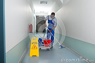 Male Janitor Cleaning Floor Stock Photo