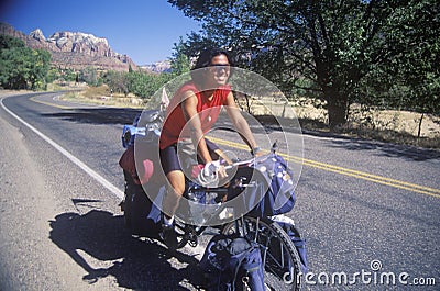 Male Japanese tourist bicycling in Zion National Park, Utah Editorial Stock Photo