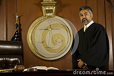 Male Judge Standing In Court Room Stock Photo