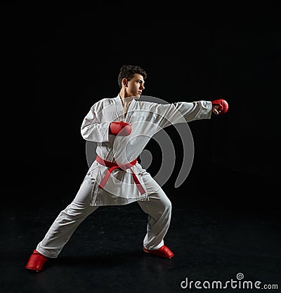 Male karate fighter in white kimono and red gloves Stock Photo